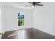 A cozy bedroom is brightened by a large window and has rich hardwood floors at 9263 Club View Trce, Riverdale, GA 30274