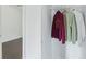 A bright closet featuring clothing rack with hanging shirts, offering convenient storage in a home at 9263 Club View Trce, Riverdale, GA 30274
