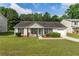 Charming one-story home with well-maintained lawn and inviting front porch at 9263 Club View Trce, Riverdale, GA 30274