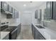 Updated kitchen with gray cabinets, light countertops, and new stainless steel oven at 9263 Club View Trce, Riverdale, GA 30274