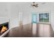 Bright living room featuring fireplace, ceiling fan, and stylish hardwood floors at 9263 Club View Trce, Riverdale, GA 30274