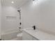 Bathroom featuring a shower over tub combination, white tile, and black hardware at 3205 Bold Springs Rd, Dacula, GA 30019
