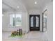 Elegant entryway features black framed glass doors and hardwood floors, adding modern style to the space at 3205 Bold Springs Rd, Dacula, GA 30019