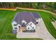 Aerial view showcasing the front exterior of the home, landscaping and long driveway at 3205 Bold Springs Rd, Dacula, GA 30019
