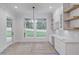 Modern kitchen with open shelving, custom cabinets, and a large window overlooking backyard at 3205 Bold Springs Rd, Dacula, GA 30019