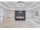 Spacious living room with a modern fireplace, built-in seating, and a decorative chandelier at 3205 Bold Springs Rd, Dacula, GA 30019