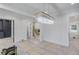 Bright open-concept living space with modern lighting, and hardwood floors prepped for finishing touches at 3205 Bold Springs Rd, Dacula, GA 30019
