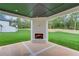 Covered patio featuring a white painted brick fireplace with black interior and backyard views at 3205 Bold Springs Rd, Dacula, GA 30019