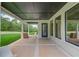 Covered patio with black ceiling, pillars, large windows, and a door overlooking backyard at 3205 Bold Springs Rd, Dacula, GA 30019