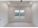 Bright, open room with a large window and neutral walls, ready for personalization at 3205 Bold Springs Rd, Dacula, GA 30019
