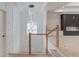 Stylish staircase featuring modern lighting, wood accents, and a view into the adjacent living space at 3205 Bold Springs Rd, Dacula, GA 30019