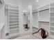 Spacious walk-in closet featuring custom shelving, ample storage, and a full-length mirror at 3205 Bold Springs Rd, Dacula, GA 30019