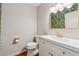 Stylish bathroom with a modern vanity, gold fixtures, and vibrant banana leaf wallpaper at 346 Carpenter Dr # 77, Sandy Springs, GA 30328
