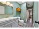 Stylish bathroom with mint green walls, a skylight, and modern fixtures at 346 Carpenter Dr # 77, Sandy Springs, GA 30328