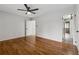 Bedroom featuring hardwood floors, a ceiling fan, and views into the hallway and a bathroom at 346 Carpenter Dr # 77, Sandy Springs, GA 30328