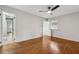 Bedroom featuring a ceiling fan, hardwood floors, a window, and hallway views at 346 Carpenter Dr # 77, Sandy Springs, GA 30328