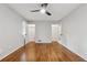 Bedroom featuring hardwood floors, a ceiling fan, and two closet doors at 346 Carpenter Dr # 77, Sandy Springs, GA 30328