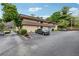Two-story brick building with landscaping, parking, and mature trees at 346 Carpenter Dr # 77, Sandy Springs, GA 30328