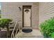 Charming front entrance featuring a tan door with decorative window and brick facade at 346 Carpenter Dr # 77, Sandy Springs, GA 30328