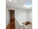 Hallway featuring a skylight, hardwood floors and geometric-designed accent wall at 346 Carpenter Dr # 77, Sandy Springs, GA 30328