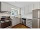 Charming kitchen features ample natural light, stainless steel appliances, and white cabinets at 346 Carpenter Dr # 77, Sandy Springs, GA 30328