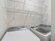 Laundry room featuring a washer, dryer, and wire shelving for storage at 346 Carpenter Dr # 77, Sandy Springs, GA 30328