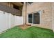 Private outdoor patio with privacy fence, artificial grass, and brick accents at 346 Carpenter Dr # 77, Sandy Springs, GA 30328