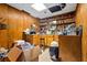 Wood paneled bar area with shelving, cabinets, bar stool, and tile flooring with lots of storage space at 5181 Saint Claire Pl, Powder Springs, GA 30127