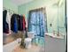 Small bathroom with shower/tub combo with clothes rack, toilet, sink, mirror, and patterned curtain at 5181 Saint Claire Pl, Powder Springs, GA 30127
