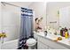 Bathroom with shower and bath, white vanity, and a functional mirror at 5181 Saint Claire Pl, Powder Springs, GA 30127