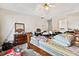 A bedroom featuring a ceiling fan, a dresser with a mirror, and carpet flooring at 5181 Saint Claire Pl, Powder Springs, GA 30127