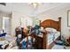A bedroom with a large carved bed frame and a ceiling fan at 5181 Saint Claire Pl, Powder Springs, GA 30127