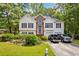Charming two-story home with a well-manicured lawn and inviting curb appeal surrounded by mature trees at 5181 Saint Claire Pl, Powder Springs, GA 30127