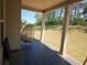 Cozy back porch with patio flooring and chair overlooking a large backyard with a black metal fence at 812 Graeme Dr, Mcdonough, GA 30252