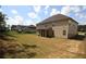 Expansive backyard showcasing lush green grass, mature trees, and a classic wooden fence at 812 Graeme Dr, Mcdonough, GA 30252