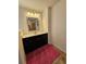 Updated bathroom features a vanity with dark wood cabinetry, sink, mirror and bright lighting at 812 Graeme Dr, Mcdonough, GA 30252