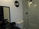 Bathroom with a modern toilet, shower, and a mirror in a well-lit space at 812 Graeme Dr, Mcdonough, GA 30252