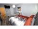 A well-lit bedroom with a comfortable bed, stylish mirror, and a modern light fixture at 812 Graeme Dr, Mcdonough, GA 30252