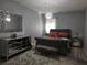Elegant bedroom with a tufted bed, mirrored furniture, a plush rug, and stylish lighting at 812 Graeme Dr, Mcdonough, GA 30252