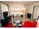 A charming bedroom featuring a playful black and white theme, fun decorations, and a cozy four-poster bed at 812 Graeme Dr, Mcdonough, GA 30252