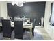 Elegant dining room features a modern chandelier, black accent wall, and a sleek dining table at 812 Graeme Dr, Mcdonough, GA 30252