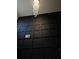 Stunning two-story entryway featuring a modern chandelier and a dark accent wall with decorative trim at 812 Graeme Dr, Mcdonough, GA 30252