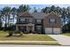 Charming brick two-story home with well-manicured lawn and attached two-car garage at 812 Graeme Dr, Mcdonough, GA 30252