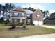 Charming brick two-story home with a two-car garage and manicured lawn, offering curb appeal at 812 Graeme Dr, Mcdonough, GA 30252
