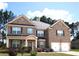 Charming two-story brick home with a well-maintained front yard and a two-car garage at 812 Graeme Dr, Mcdonough, GA 30252