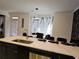 Kitchen features updated appliances, quartz counters, and view of breakfast nook with bay window at 812 Graeme Dr, Mcdonough, GA 30252