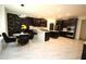 Open concept kitchen features a dining area, large island, black cabinets, and marble flooring at 812 Graeme Dr, Mcdonough, GA 30252