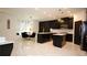 Contemporary kitchen with black cabinets, white countertops, stainless steel appliances, and marble flooring at 812 Graeme Dr, Mcdonough, GA 30252