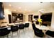 Bright, open kitchen design featuring black cabinetry, marble floors, and modern lighting fixtures at 812 Graeme Dr, Mcdonough, GA 30252