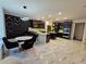 Modern eat-in kitchen with dark cabinets, island seating, and stylish light fixtures at 812 Graeme Dr, Mcdonough, GA 30252